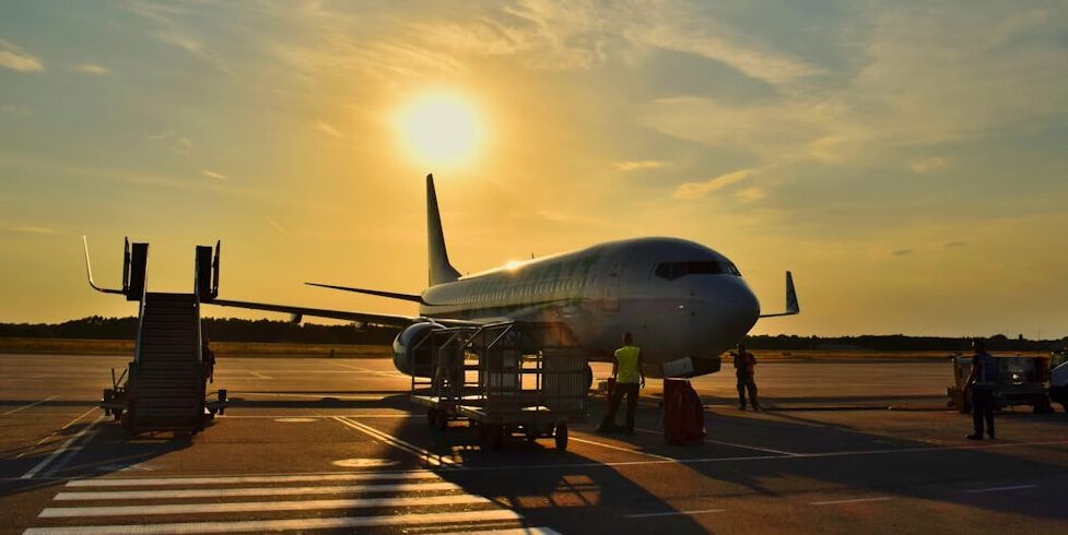 white airplane parked during daytime
